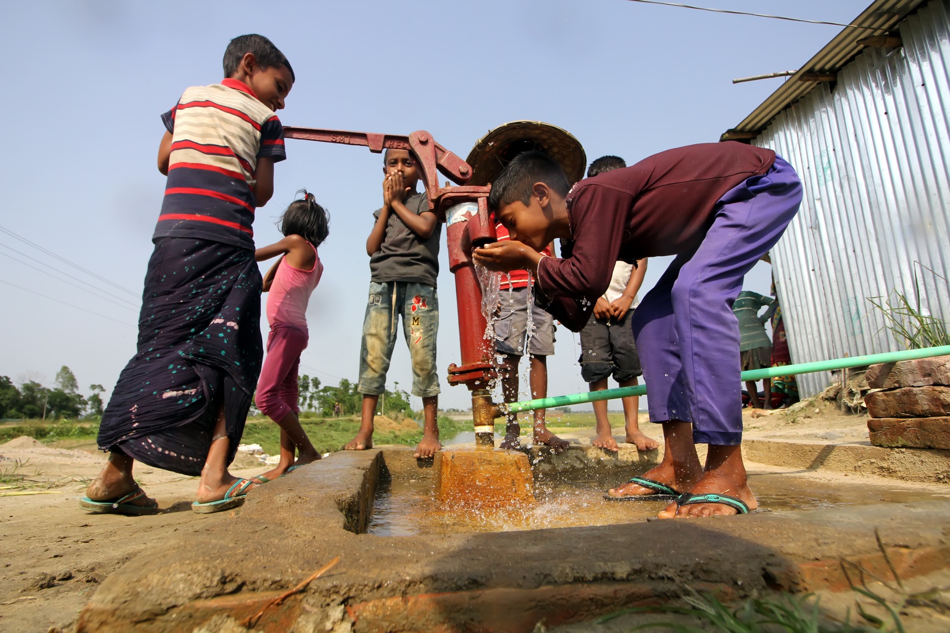 Children using water pump